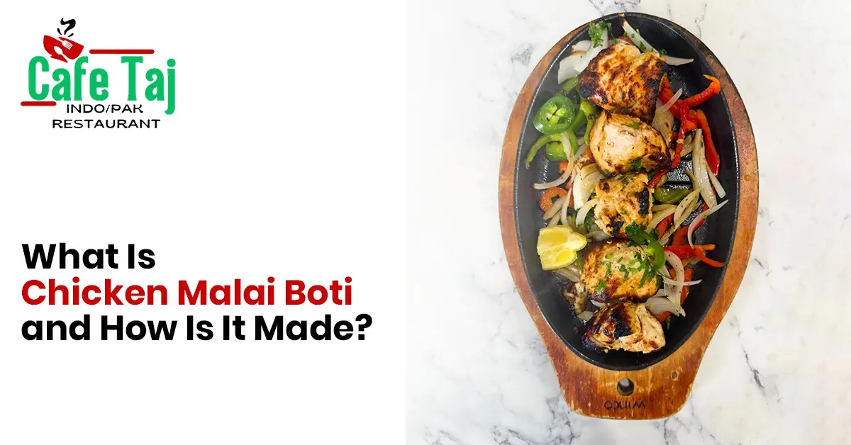 Cafe Taj Chicken Malai Boti on sizzling platter with grilled chicken, fresh vegetables, and authentic spices in Houston, TX