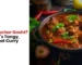 Cafe Taj image featuring Achar Gosht, a tangy and spicy Pakistani meat curry served with rich gravy, chilies, and fresh herbs