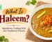 Cafe Taj Pakistani Haleem featuring a thick, slow-cooked meat and lentil dish garnished with ginger and crispy fried onions.
